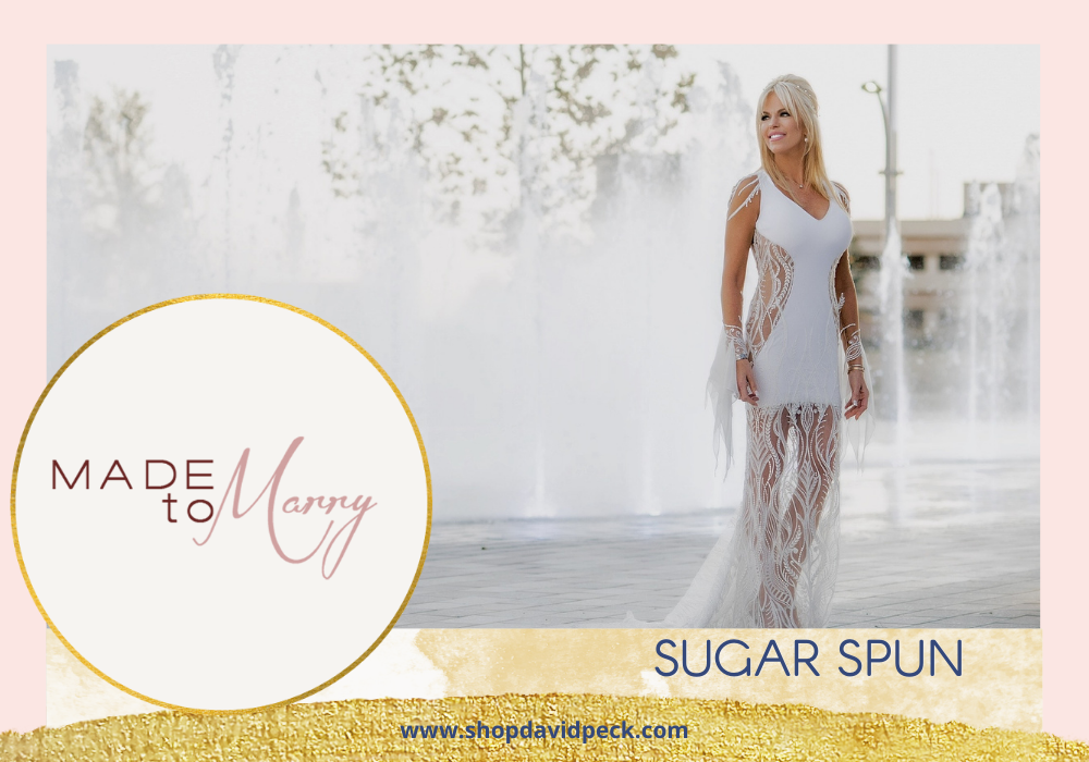 Made to Marry. Blonde bride in unique mini wedding dress standing in front of fountain at Houston Smart Financial Center in Sugarland.