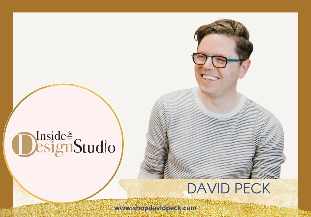 Inside the design studio. Brunette man with glasses laughing in striped tee.
