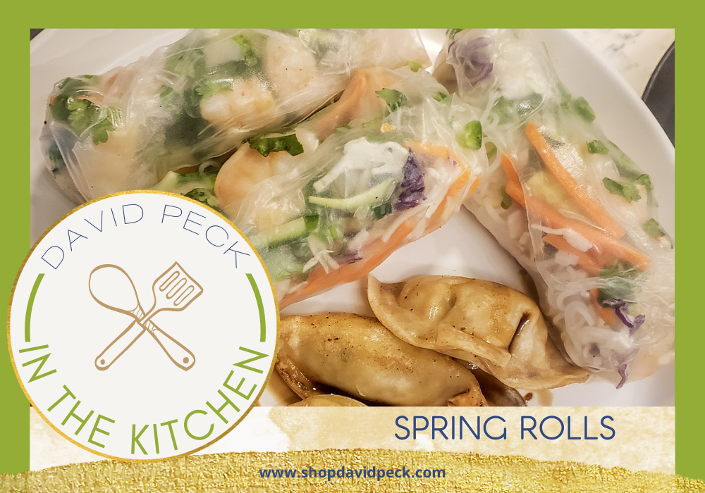 In the kitchen. Homemade shrimp spring rolls with cabbage and carrots on a white plate