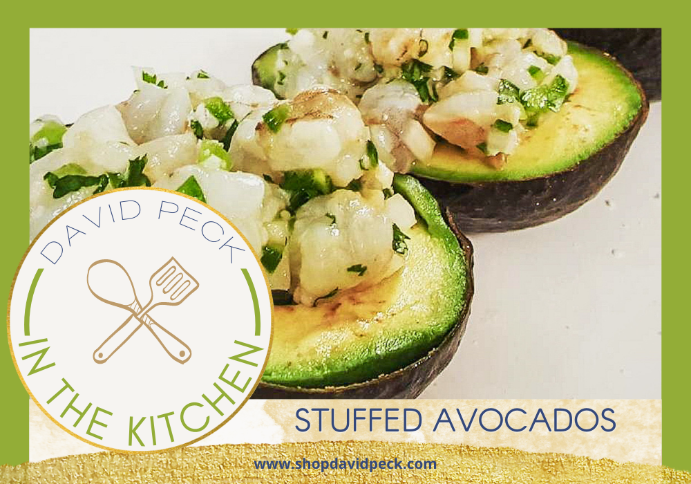 In the kitchen. Avocados halved on a plate stuffed with ceviche and buffalo chicken