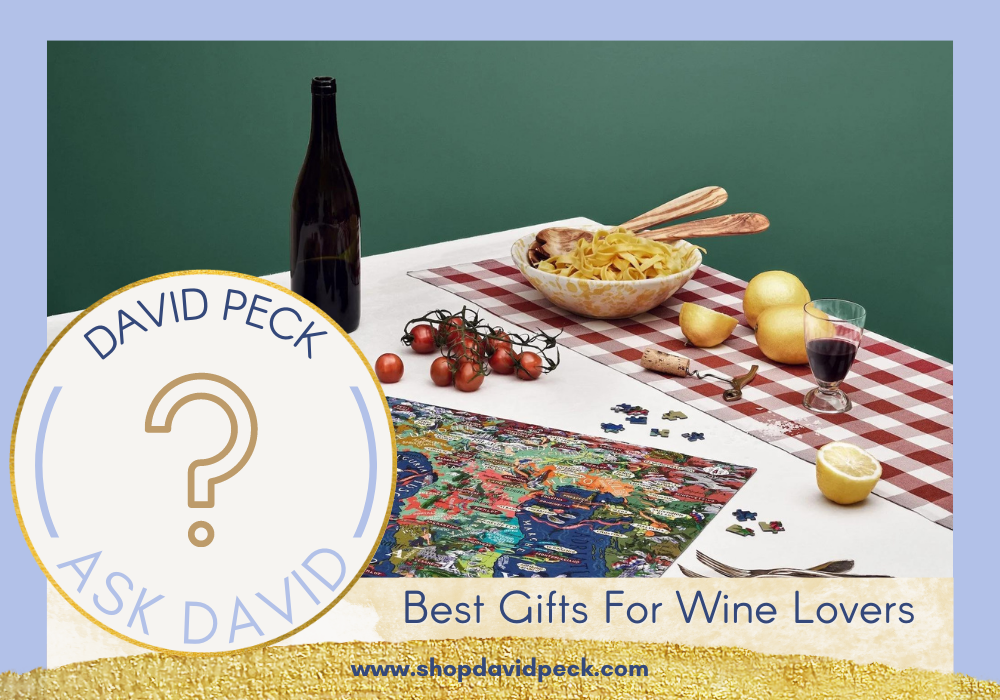 Water and Wines puzzles on the table next to a bottle of wine, a cup of wine, pasta, lemons, and tomatoes.