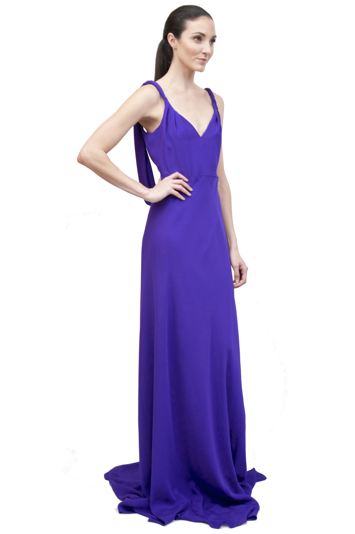 A woman standing and posing in a purple, draped back gown with a bias cut skirt. Designed by David Peck