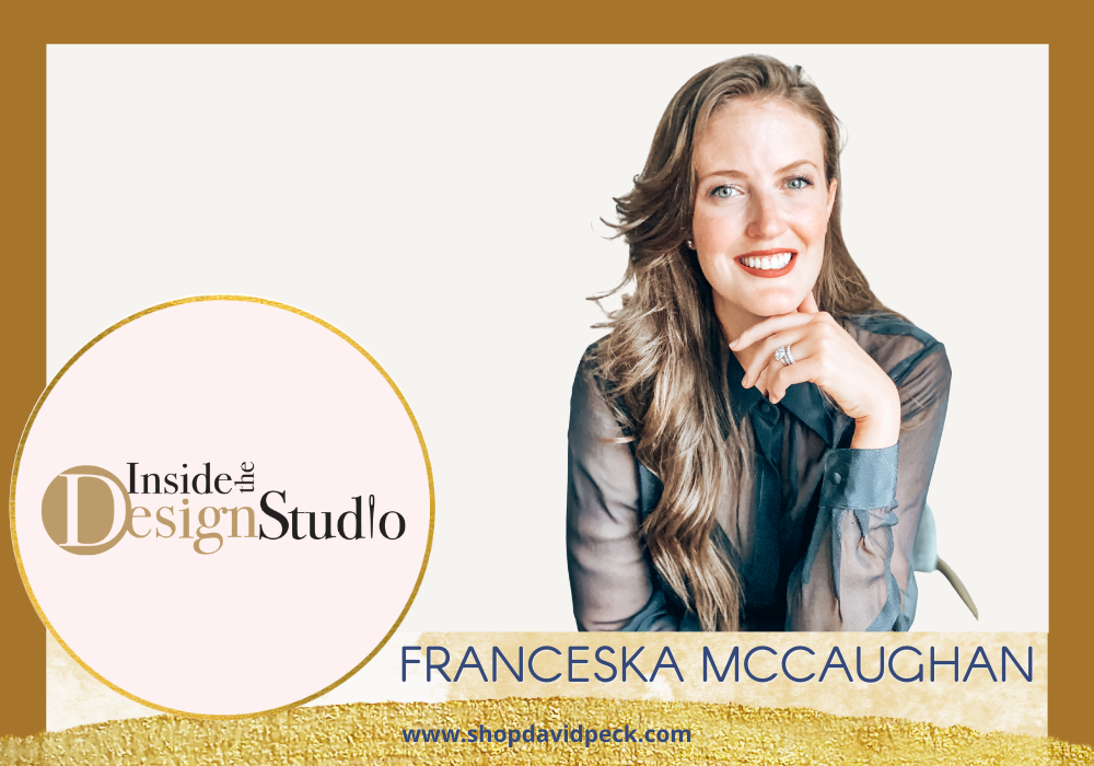 Inside the Design Studio. brunette smiling in blue mesh blouse with hand on chin.