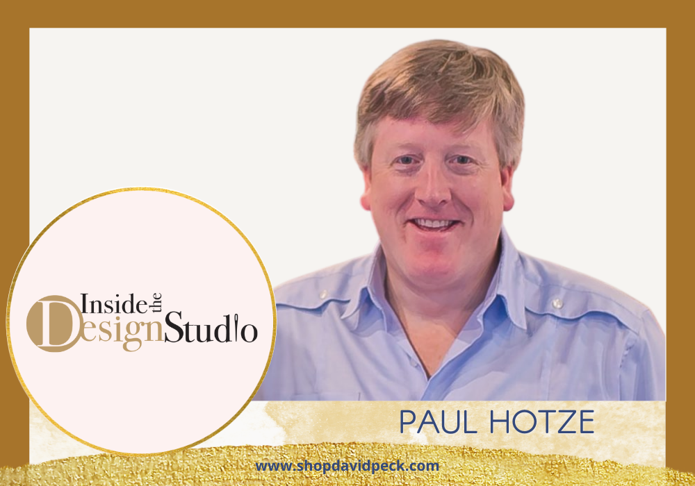 Inside the Design Studio. Blonde man with blue button down smiling.