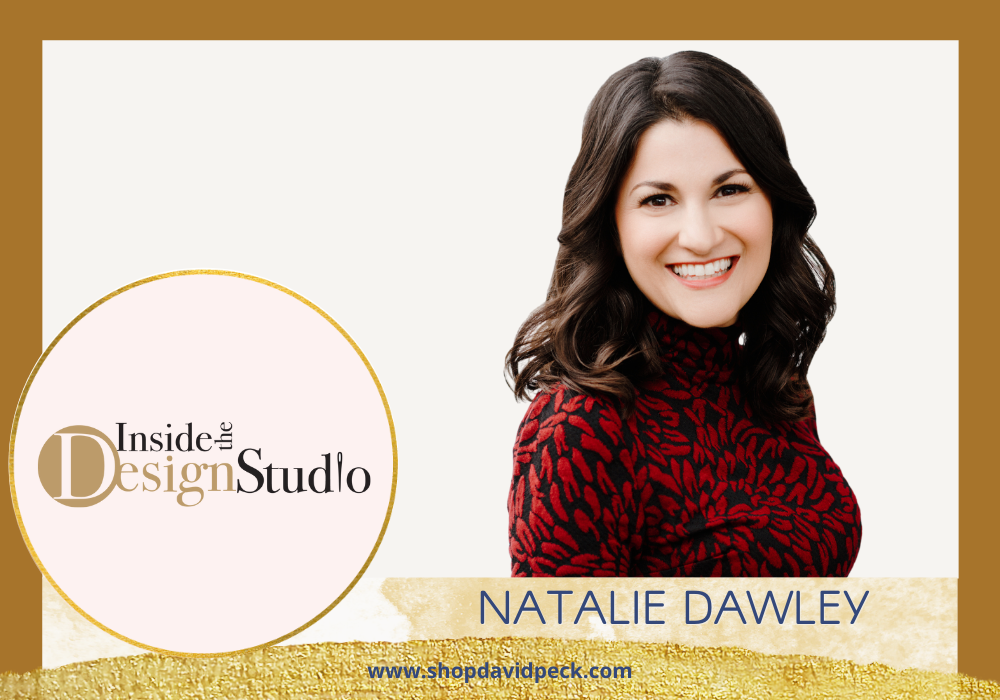Inside the Design Studio. Headshot of smiling brunette woman in black and red dress.