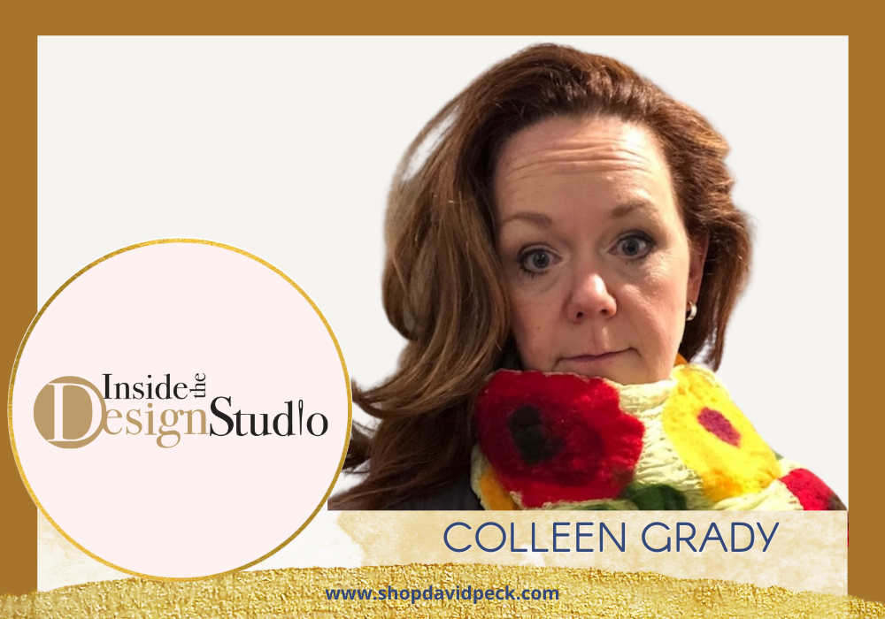 Inside the design studio. Red head holding flowers.