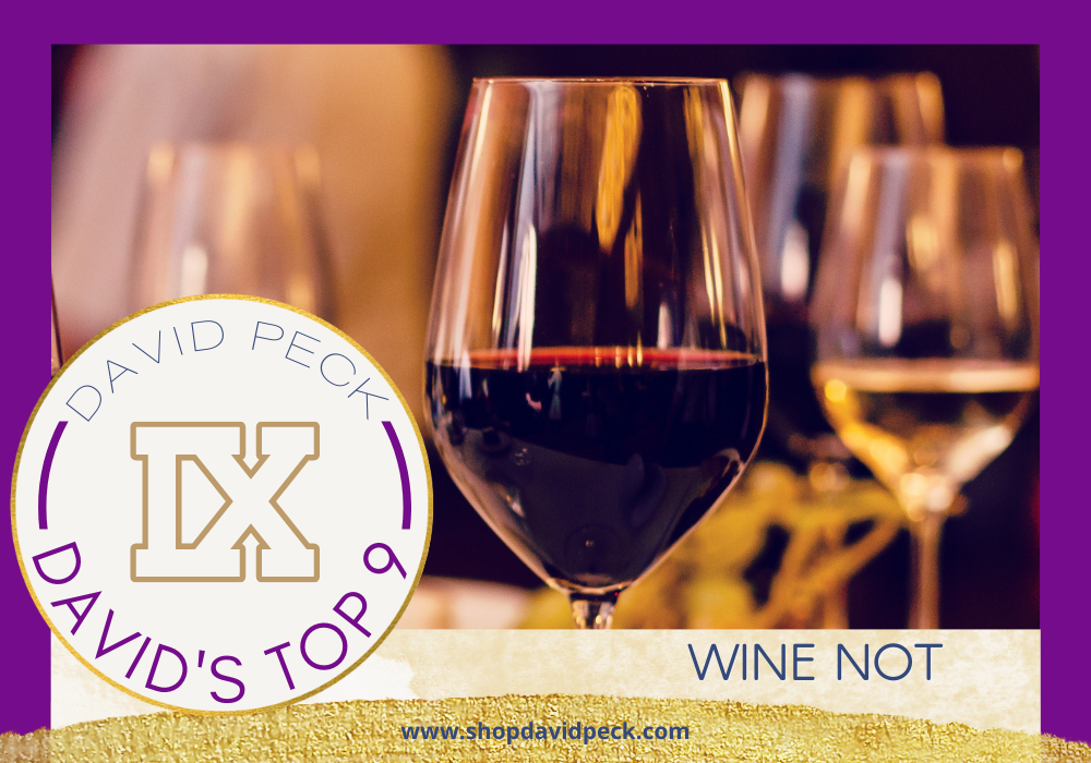 David's top 9. stemmed glasses of red and white wine on table.