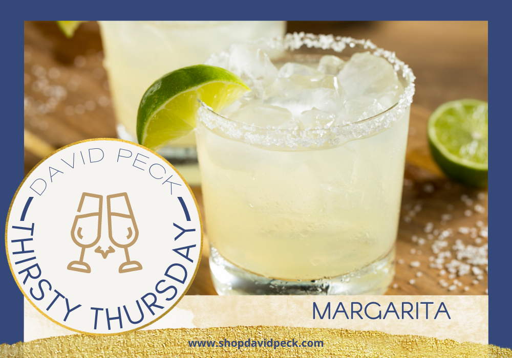 Thirsty Thursday. Tumbler glass with margarita with salt rim and a lime garnish. Lime and salt on the table