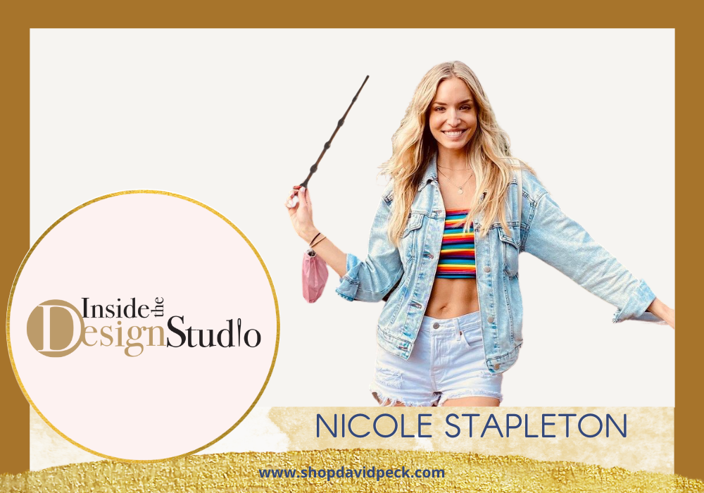 Inside the Design Studio. Long blonde haired woman standing in multicolor tube top, denim jacket and denim shorts holding a Harry Potter Wand