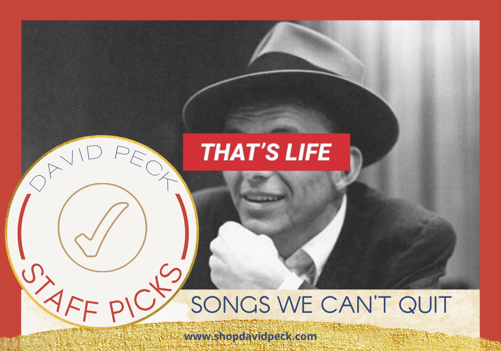 staff picks. black and white photo of frank sinatra wearing a black sports coat, white collared shirt, and hat with a red banner across his eyes with the text that's life.