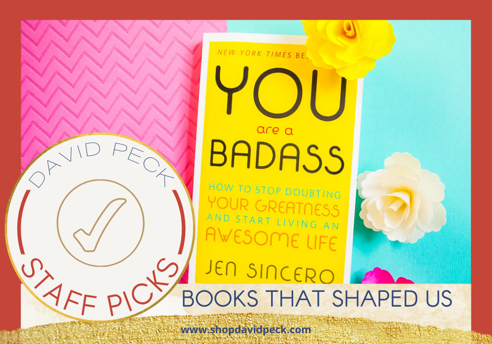 staff picks. cover of paperback book you are a badass. on pink and blue background with flowers.