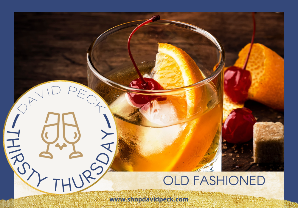 Thirsty Thursday. Tumbler with an old fashioned bourbon cocktail with an orange wedge and cherry over ice