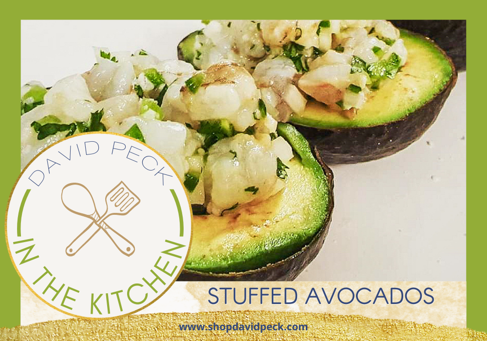 In the kitchen. Avocados halved on a plate stuffed with ceviche and buffalo chicken 