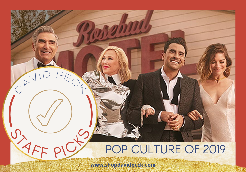 staff picks. schitts creek cast in front of the rosebud motel walking arm and arm