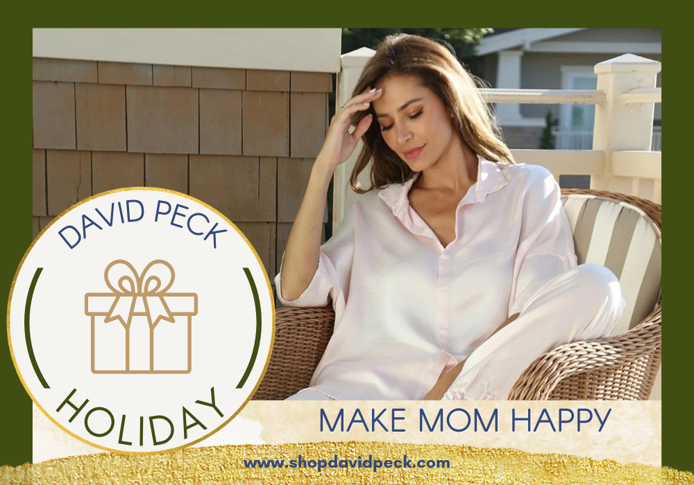 woman sitting on a porch at the beach wearing a pale pink pajama top by PJ Harlow that is sold at David Peck