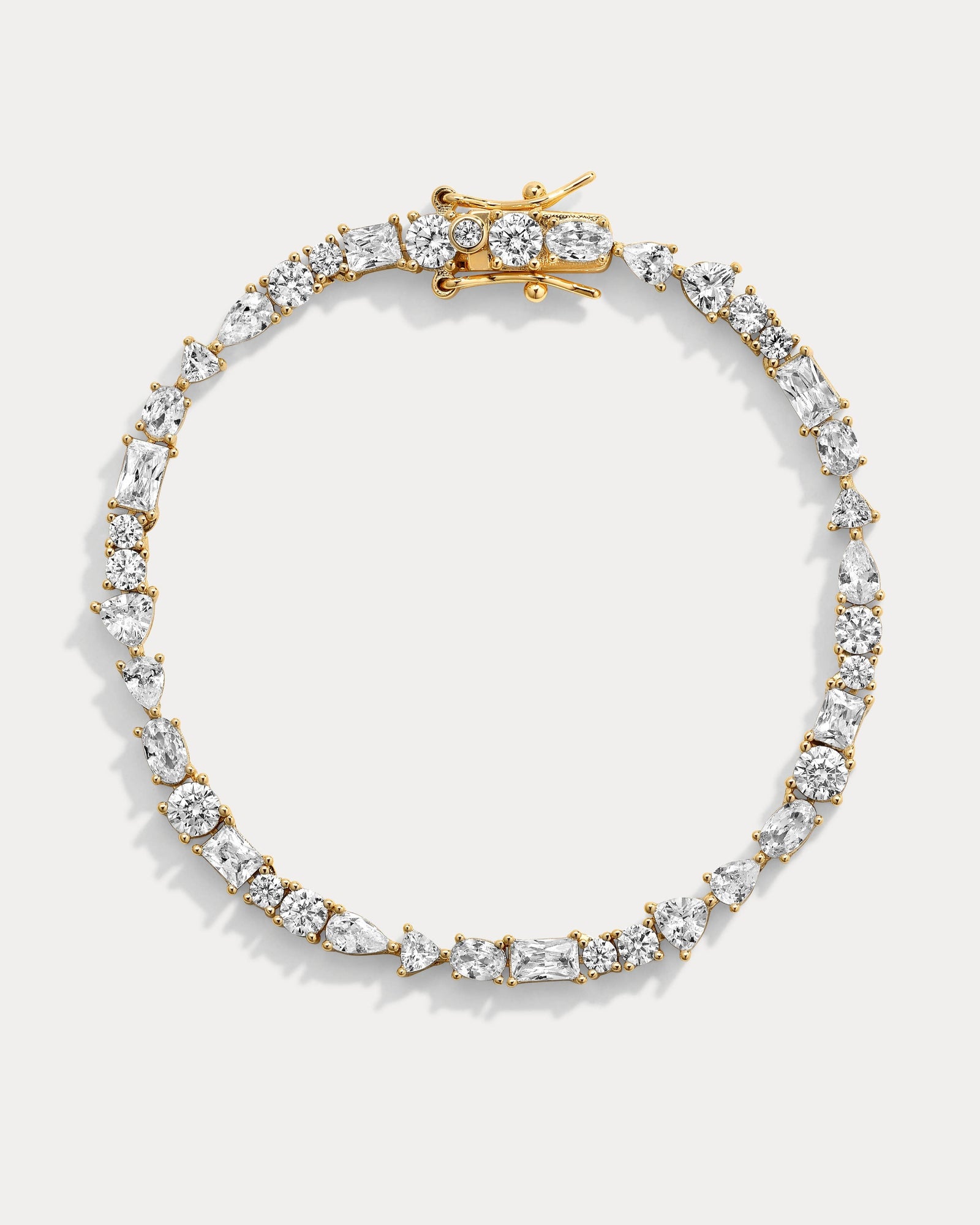 Gold and diamond bracelet on a light gray background