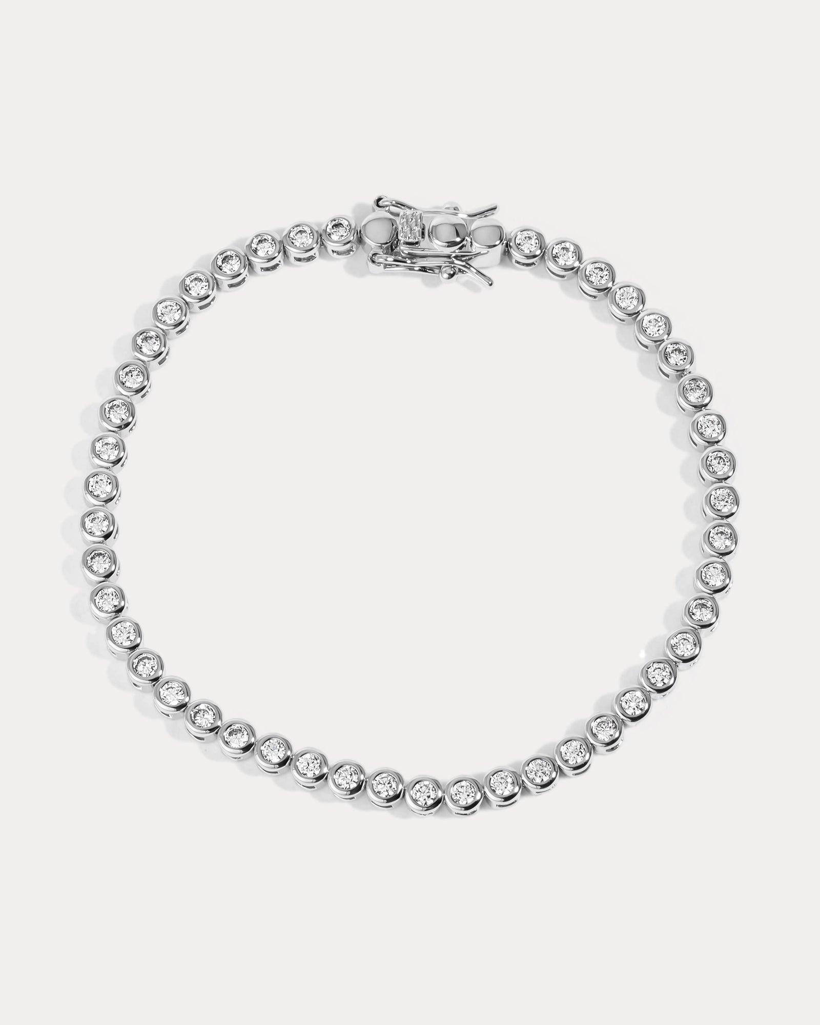 Silver bracelet with clear stones on a white background