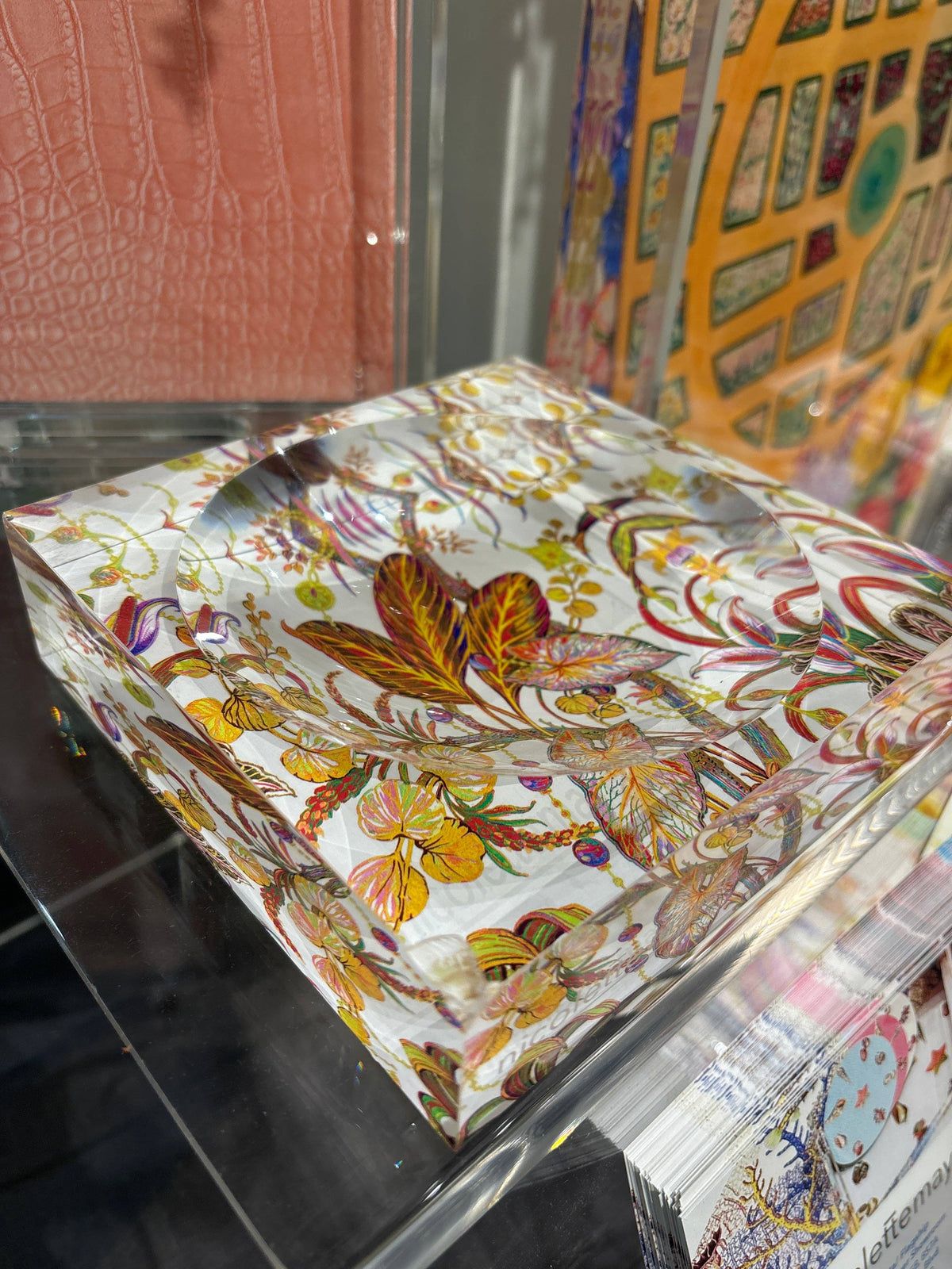 Decorative box with floral design on a glass surface