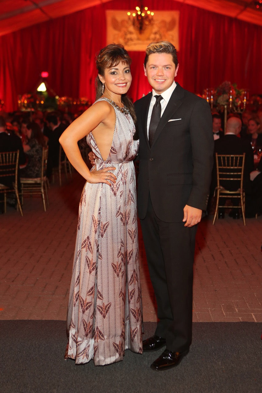 Ailyn Perez, an international opera star, posing with her hand on her hip in a custom designed silk mauve cowl neck gown by David Peck. 