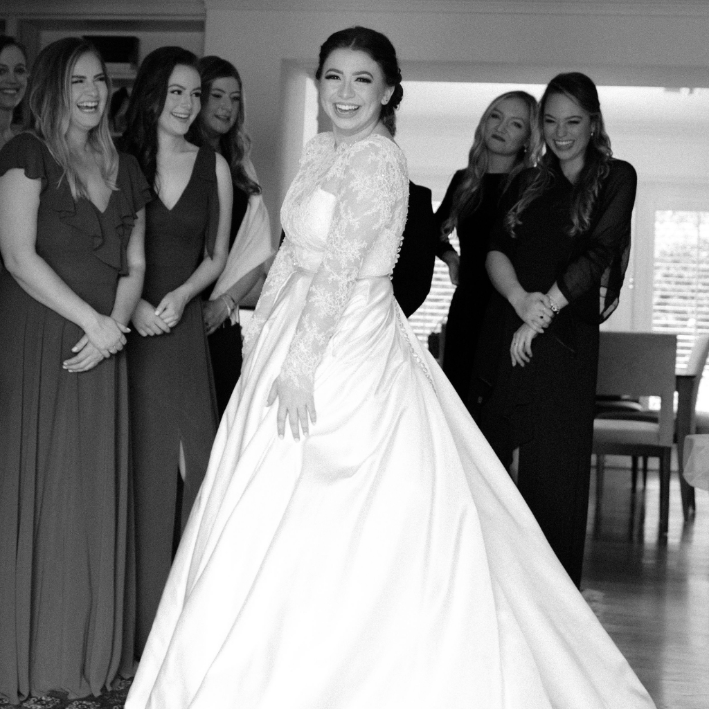 Bride Kasey French Riley in a custom satin and lace wedding gown by David Peck at her Houston wedding at the Houstonian Hotel and Spa
