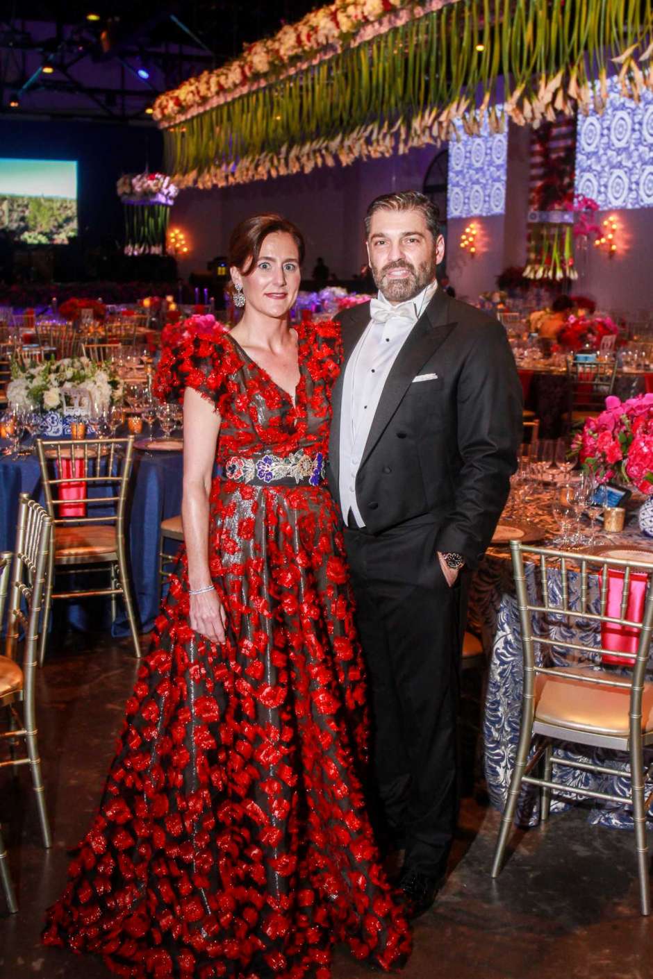 Marcia Vilas, a HGO opera chair, wearing a custom designed red floral embroidered V-neck gown by David Peck at the Houston Opera Ball.