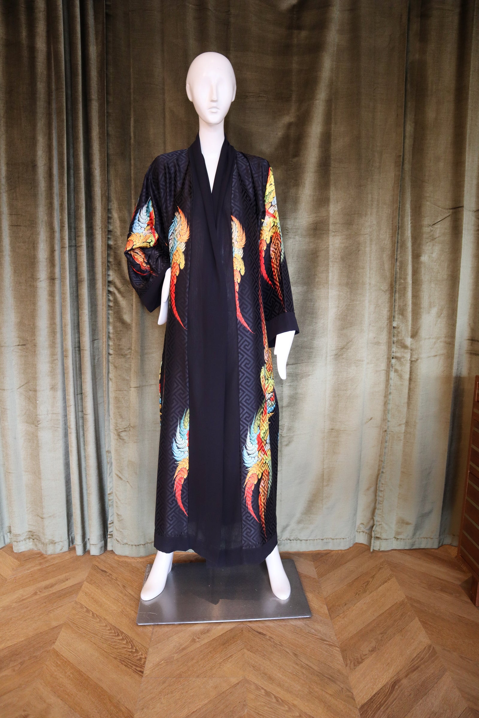 Mannequin wearing a dark blue kimono with colorful dragon designs against a plain background.