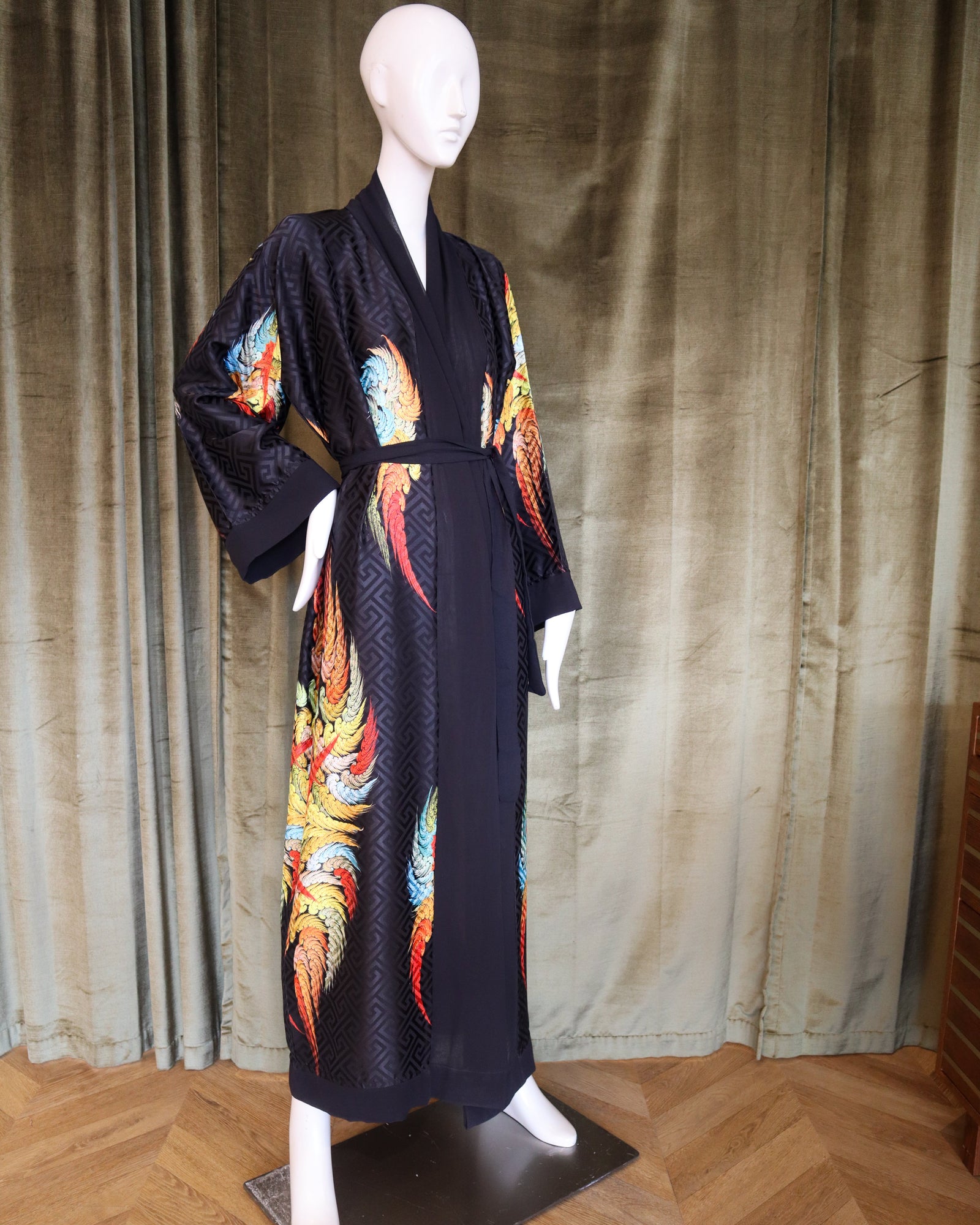 Mannequin wearing a dark blue kimono with colorful dragon designs against a plain background.